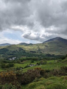 Bird's-eye view of Perthi Holiday Cottages above Beddgelert village, with Moel Hebog in the distance