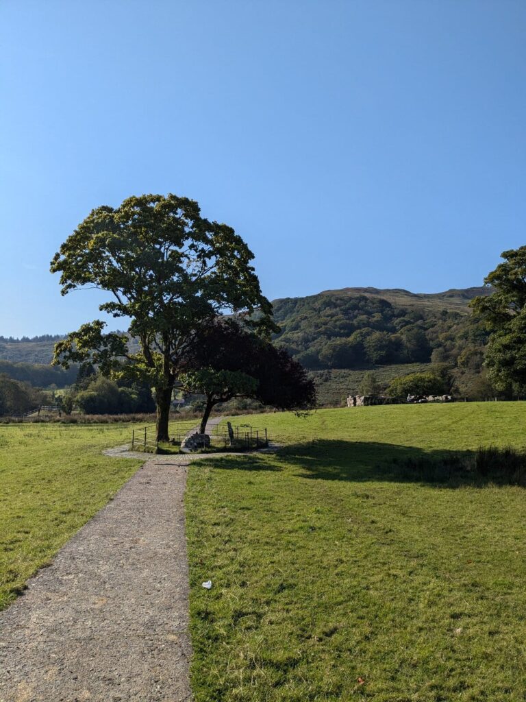 Path leading to Gelert's Grave in Beddgelert, with the River Glaslyn visible through the trees