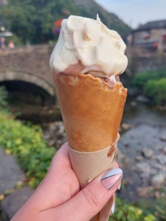 Ice cream from Glaslyn parlour in Beddgelert with the village bridge in the background