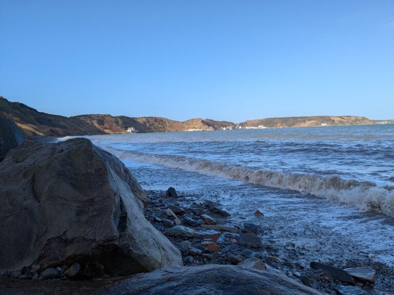 View along the beach towards the Ty Coch Inn and the fishing village of Porthdinllaen on the Llŷn Peninsula