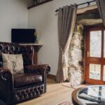 Chesterfield armchair and Smart TV — a cosy corner of the living area.
