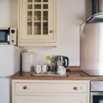 The open plan kitchen and sitting area in Ty Hebog,t his practical and comfortable space is ideal for cooking, dining and relaxing during your stay.