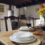 Dining area with kitchen in background