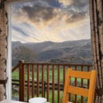 Dining area opening out onto patio and decking area with views of Eryri