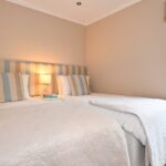 Twin bedroom with large wardrobe