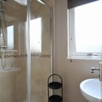 Bathroom with walk in shower and sink
